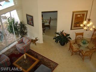 8582 Peppertree Way Naples, FL 34114 - Photo 2 of 8 a living room with furniture and a potted plant