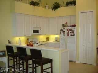 8582 Peppertree Way Naples, FL 34114 - Photo 3 of 8 a dining room with a table and chairs