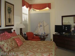 8582 Peppertree Way Naples, FL 34114 - Photo 5 of 8 a bedroom with a bed and a flat screen tv