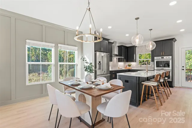 a dining room with granite countertop a table chairs and a chandelier