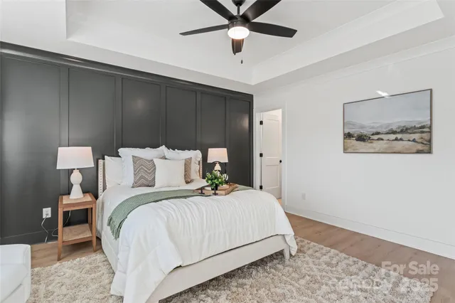 a bedroom with bed and wooden floor