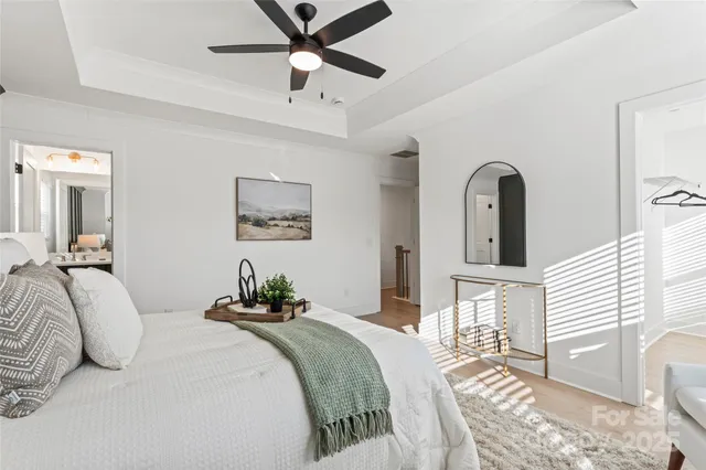 a bedroom with a bed and a chandelier