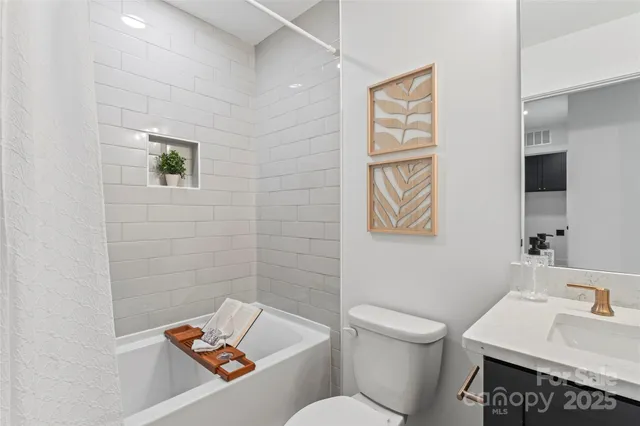 a white toilet sitting next to a bathroom sink