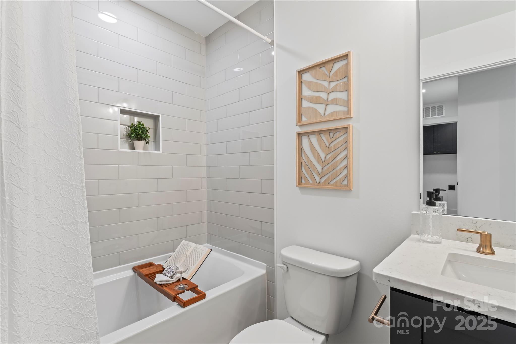 430 Bogue Drive, Unit 24 Fort Mill, SC 29708 - Photo 31 of 48 a white toilet sitting next to a bathroom sink