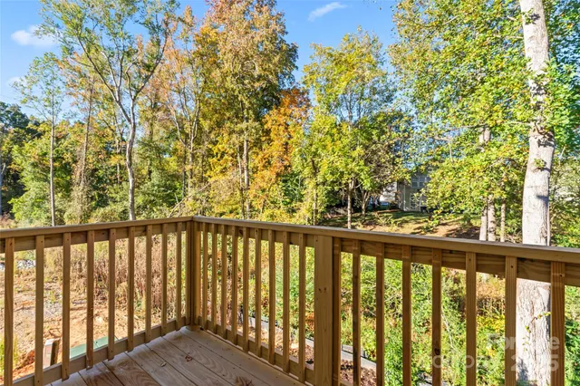 a view of a balcony with wooden fence