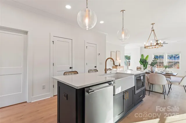 a kitchen with sink cabinets and dining table