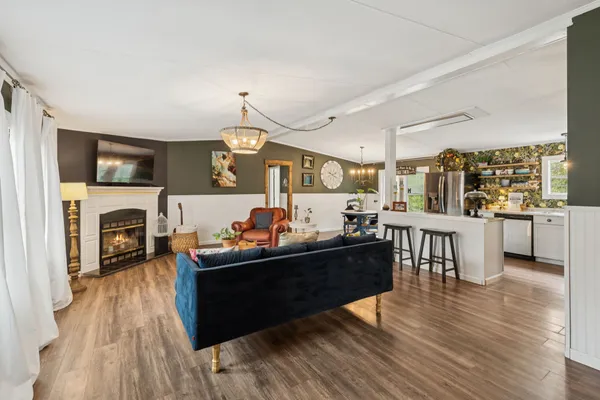 a kitchen with stainless steel appliances kitchen island granite countertop a refrigerator and a stove top oven