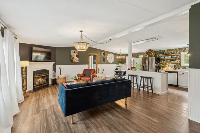 a kitchen with stainless steel appliances kitchen island granite countertop a refrigerator and a stove top oven