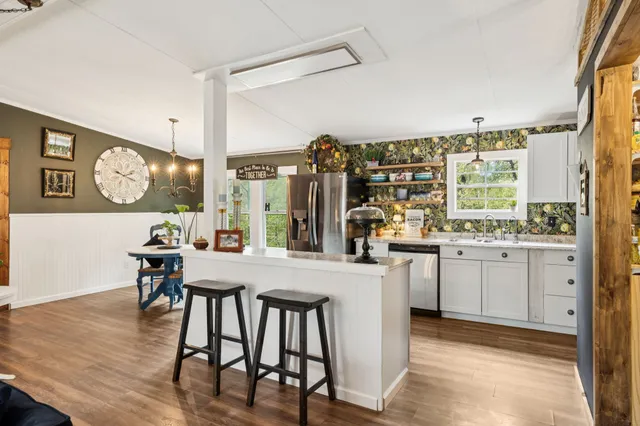 a kitchen with lots of counter top space and wooden floor