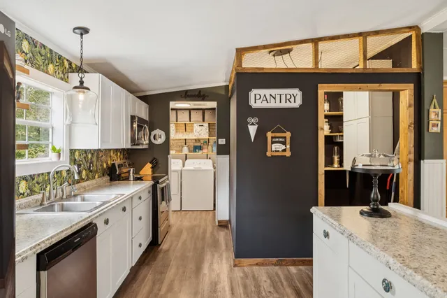 a bedroom with a large bed and a chandelier