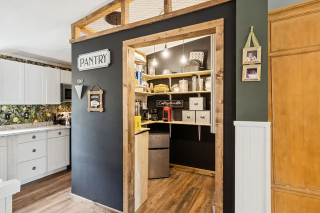 a workspace with wooden floor and a ceiling fan