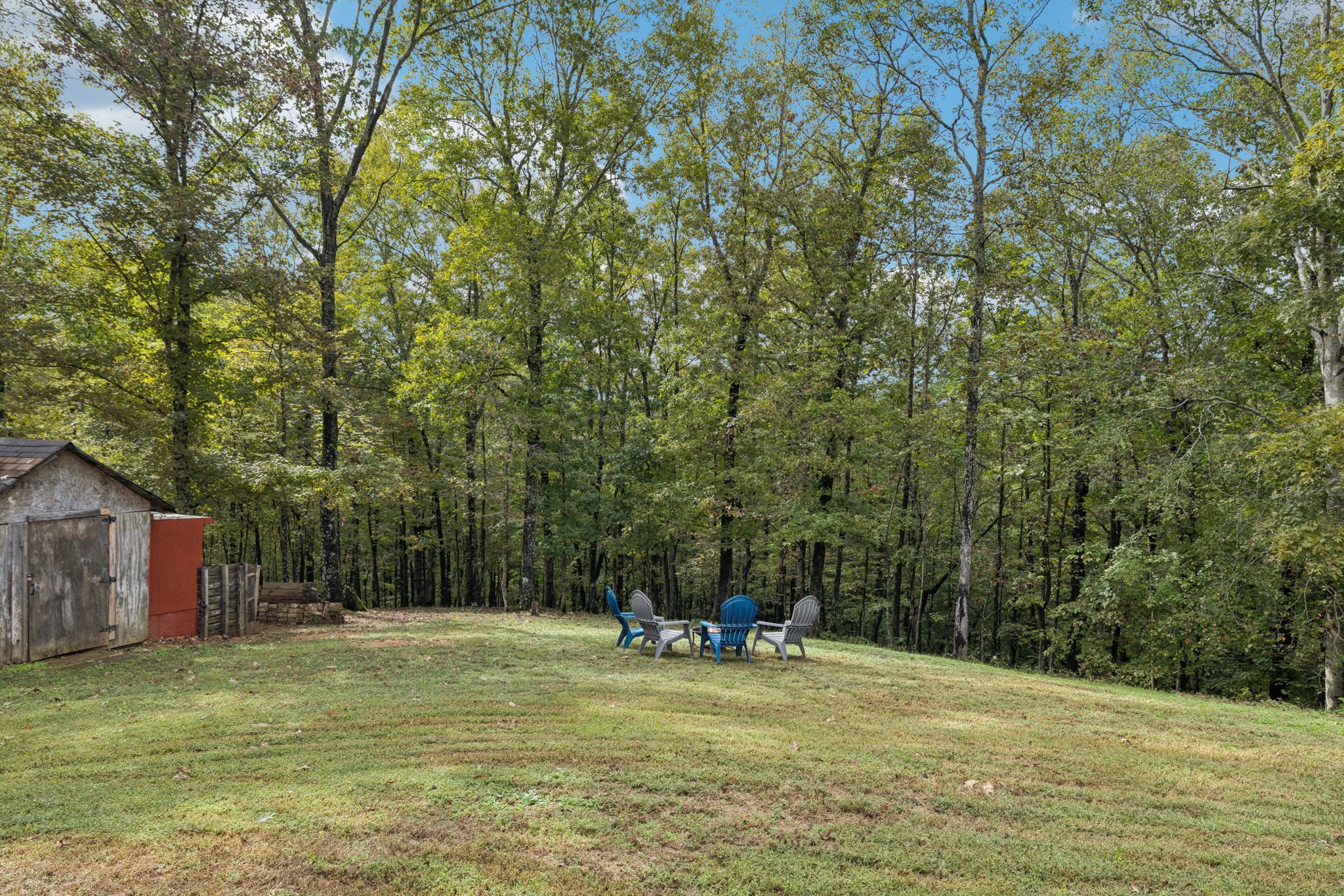 2108 Lance Court Centerville, TN 37033 - Photo 41 of 51 a backyard of a house with large trees and plants