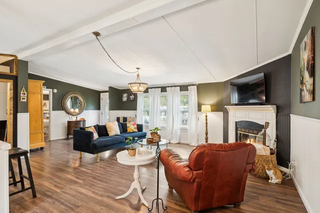 a living room with furniture fireplace and a flat screen tv