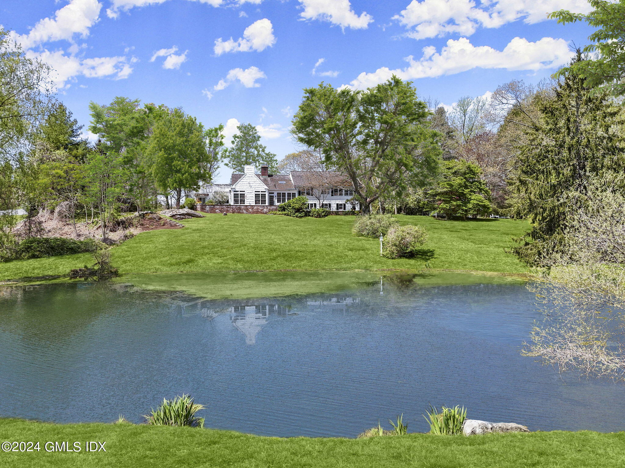 159 Bedford Road Greenwich, CT 06831 - Photo 1 of 1 a view of a lake from a yard