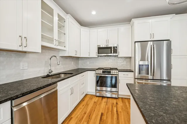 a kitchen with wooden cabinets and stainless steel appliances