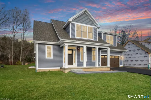 a front view of a house with a garden
