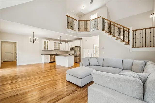 a living room with furniture and kitchen view