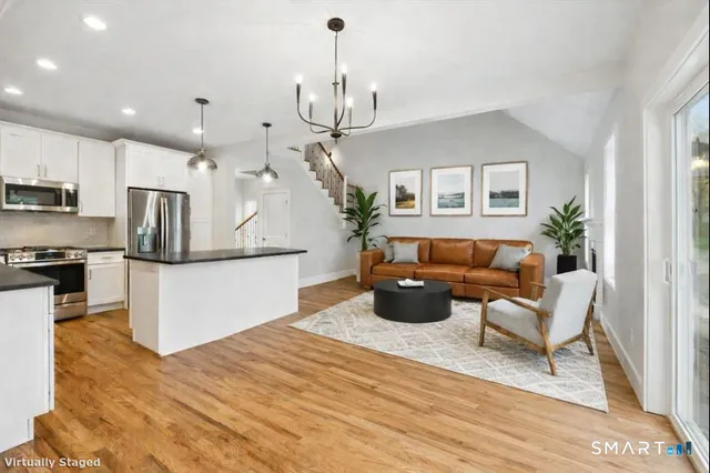 a living room with furniture and a chandelier