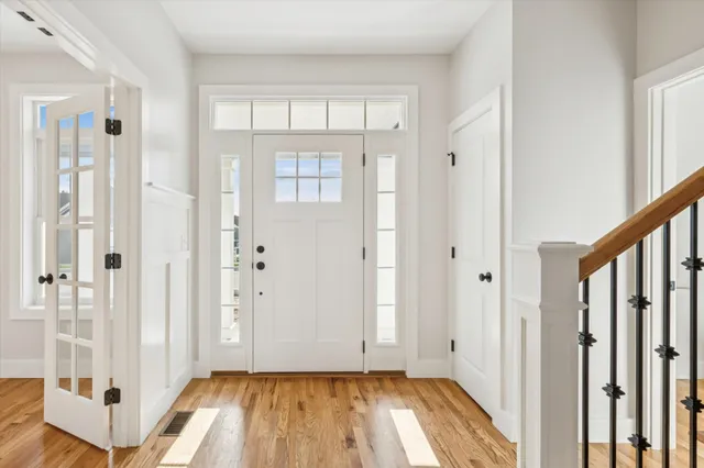 a view of an entryway with wooden floor and door