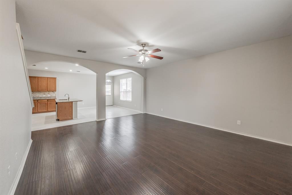 5446 Prairie Lane Grand Prairie, TX 75052 - Photo 10 of 39 a view of an empty room with a window and wooden floor