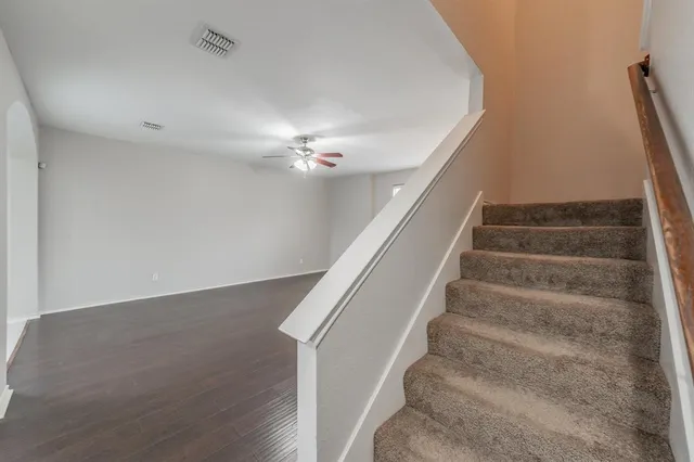 a kitchen with stainless steel appliances granite countertop a sink a stove and a refrigerator
