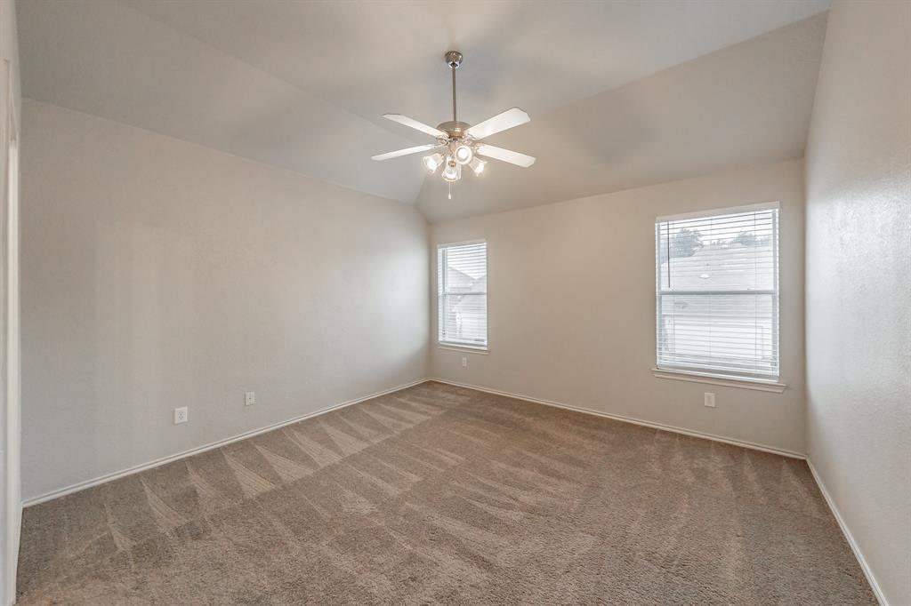 5446 Prairie Lane Grand Prairie, TX 75052 - Photo 20 of 39 an empty room with windows and chandelier fan