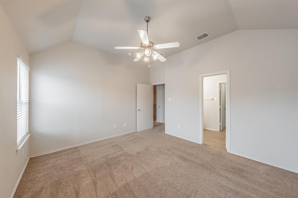 5446 Prairie Lane Grand Prairie, TX 75052 - Photo 21 of 39 an empty room with a chandelier fan and windows