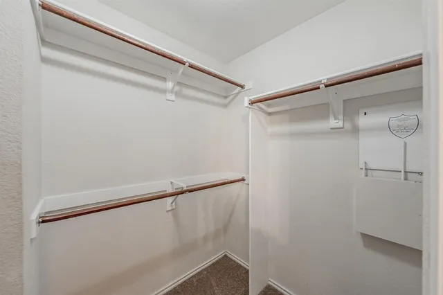 a bathroom with a granite countertop toilet sink and mirror