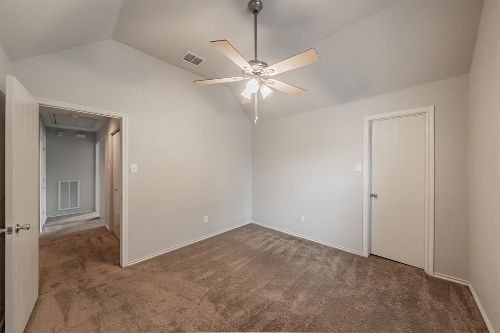 5446 Prairie Lane Grand Prairie, TX 75052 - Photo 26 of 39 an empty room with closet and a chandelier fan