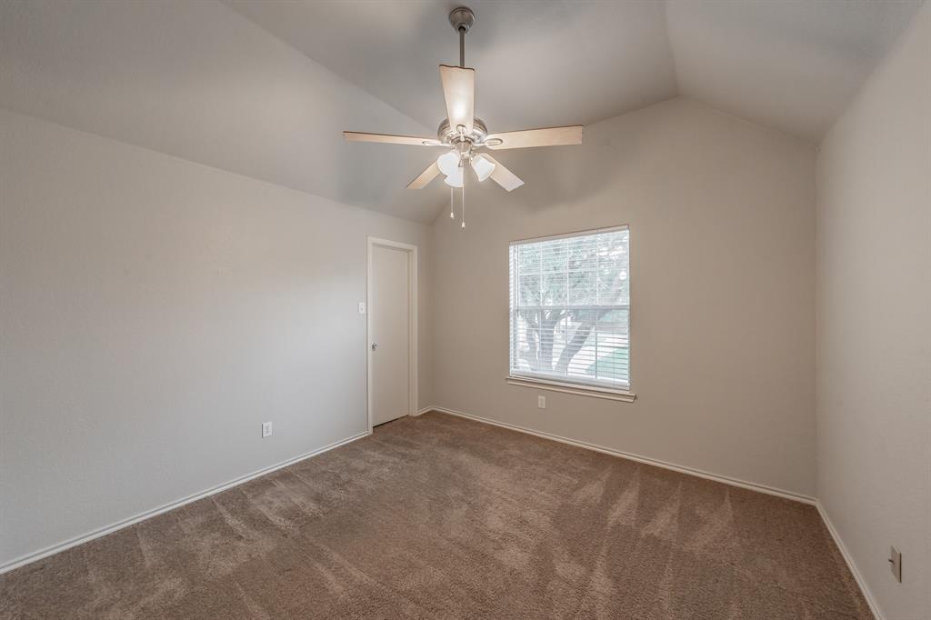 5446 Prairie Lane Grand Prairie, TX 75052 - Photo 27 of 39 an empty room with a window and a fan