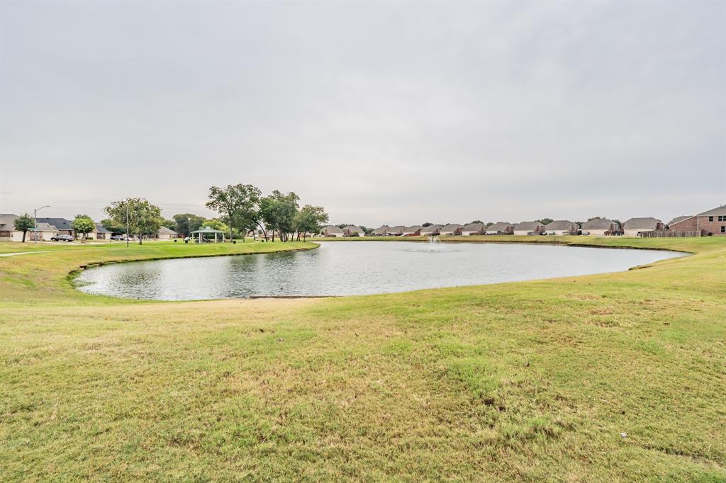 5446 Prairie Lane Grand Prairie, TX 75052 - Photo 34 of 39 a view of a lake with houses in the background