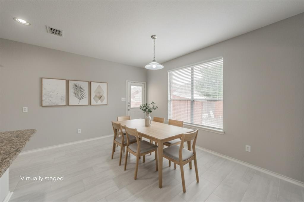 5446 Prairie Lane Grand Prairie, TX 75052 - Photo 4 of 39 a dining room with furniture a chandelier and window
