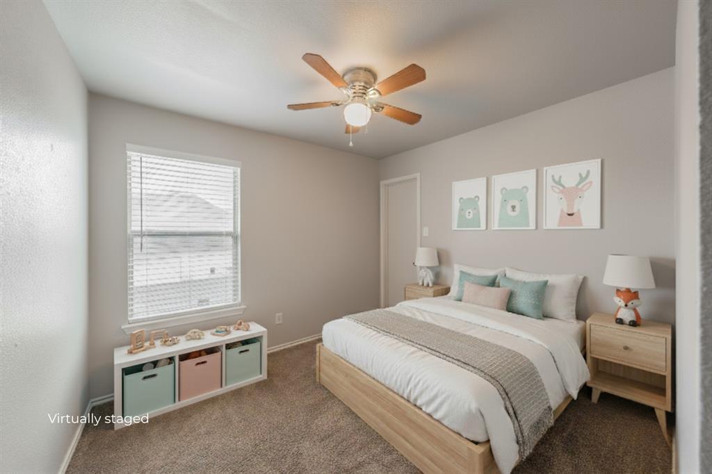 5446 Prairie Lane Grand Prairie, TX 75052 - Photo 6 of 39 a bedroom with a large bed and a chandelier