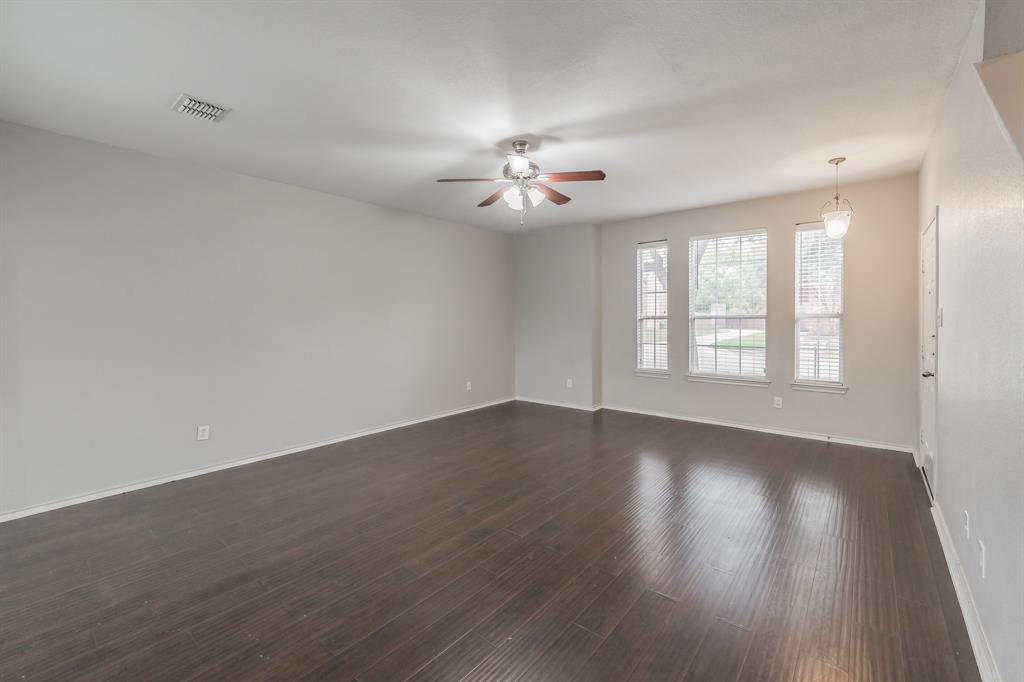 5446 Prairie Lane Grand Prairie, TX 75052 - Photo 9 of 39 wooden floor in an empty room with a window