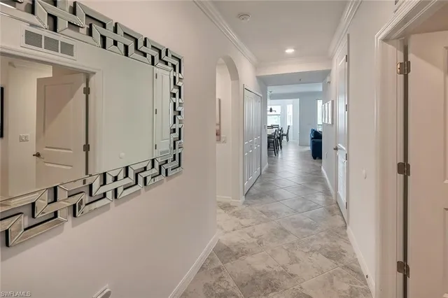 a living room with furniture a flat screen tv and a floor to ceiling window