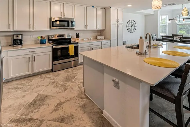 a kitchen with stainless steel appliances a sink and a refrigerator