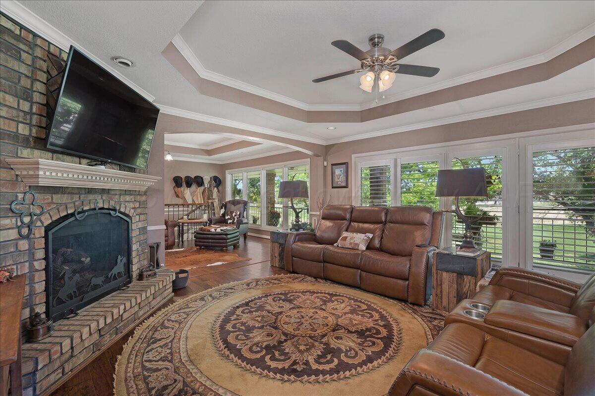 5 Locke Place Amarillo, TX 79124 - Photo 6 of 53 a living room with furniture a fireplace and a flat screen tv