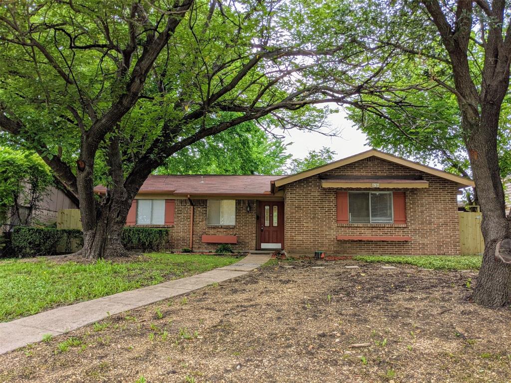 a view of a house with a tree in front of a house