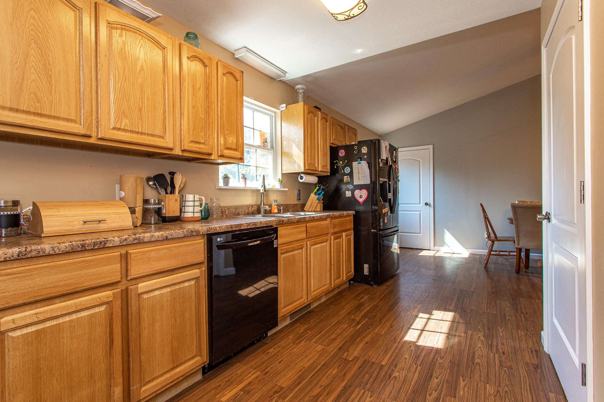 830 Collins Road Blaine, TN 37709 - Photo 12 of 34 a kitchen with stainless steel appliances granite countertop a refrigerator a sink dishwasher a stove and white countertops with wooden floor