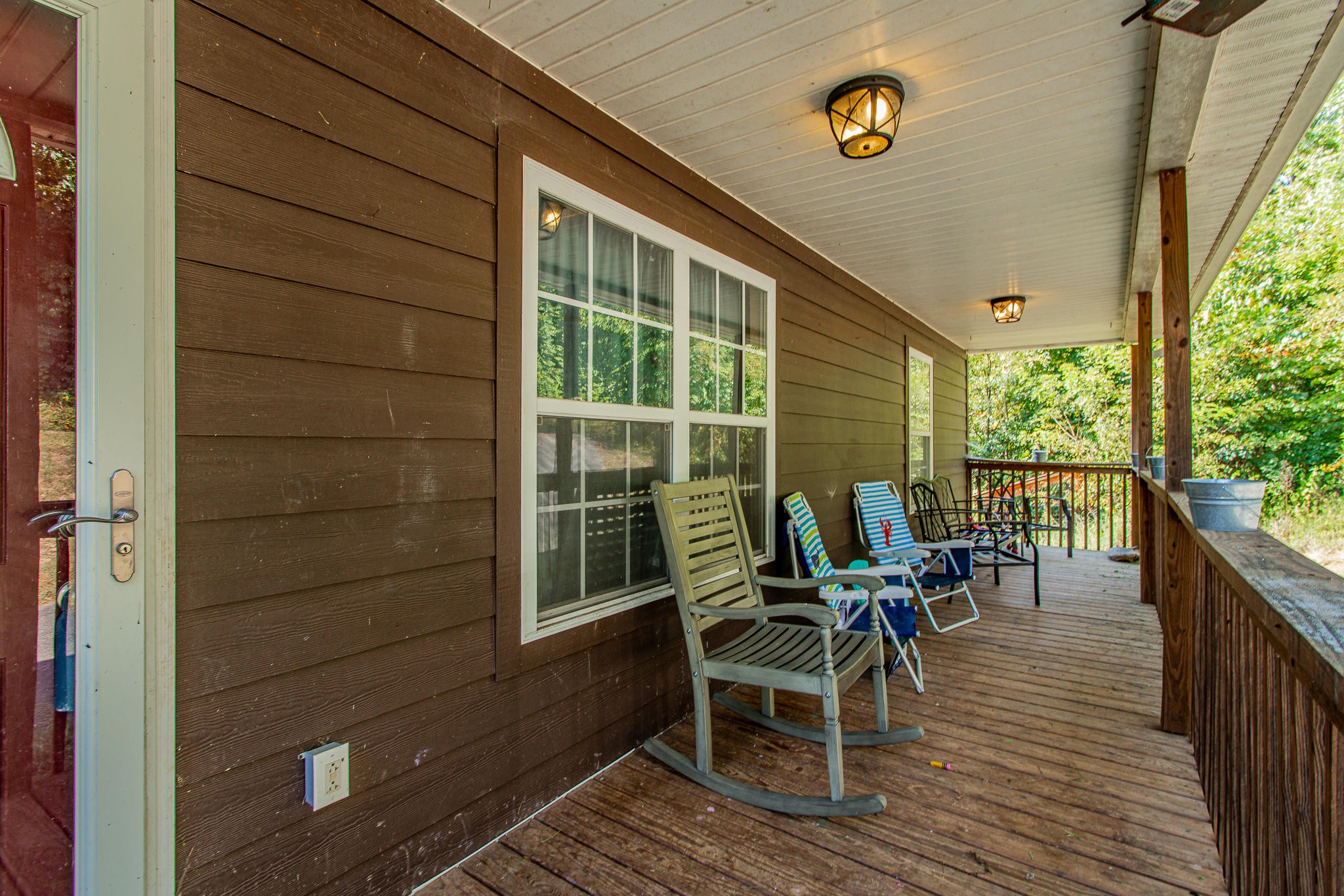 830 Collins Road Blaine, TN 37709 - Photo 3 of 34 a view of a deck with table and chairs and wooden floor