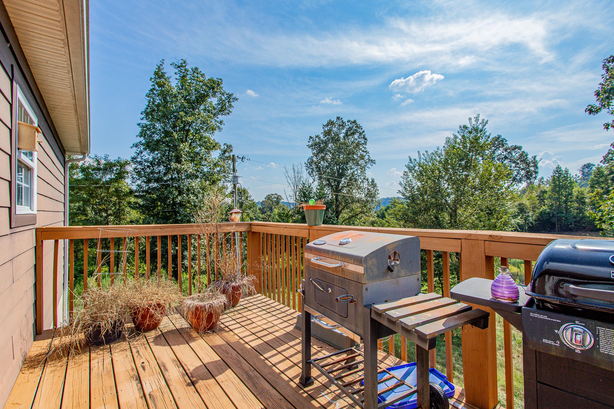 830 Collins Road Blaine, TN 37709 - Photo 4 of 34 a view of balcony with wooden floor and outdoor seating