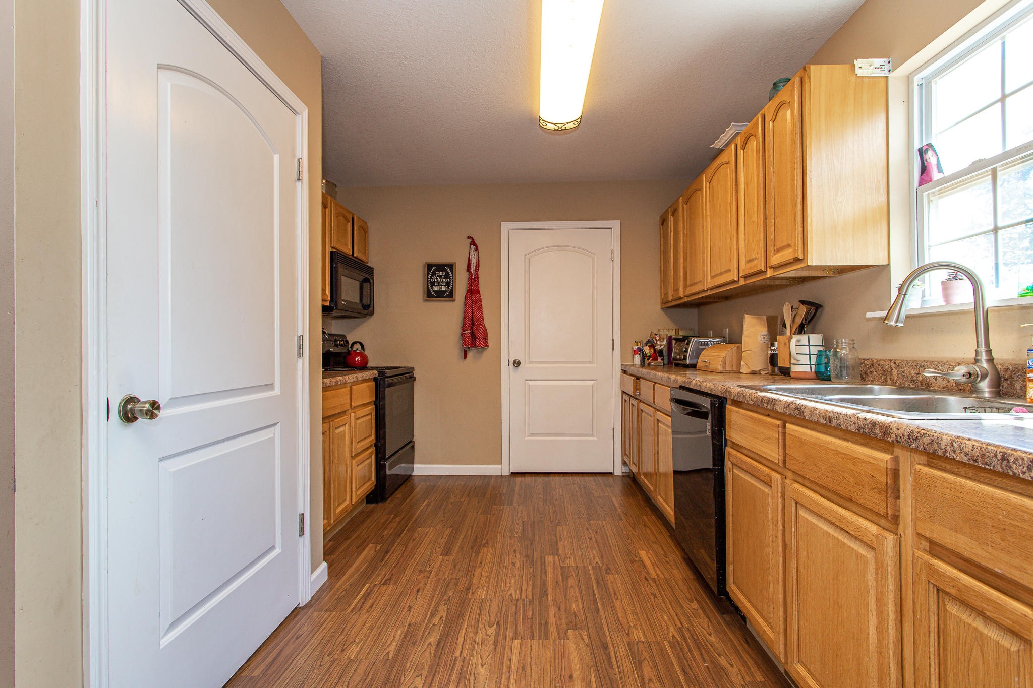 830 Collins Road Blaine, TN 37709 - Photo 10 of 34 a kitchen with a refrigerator wooden floor and a window