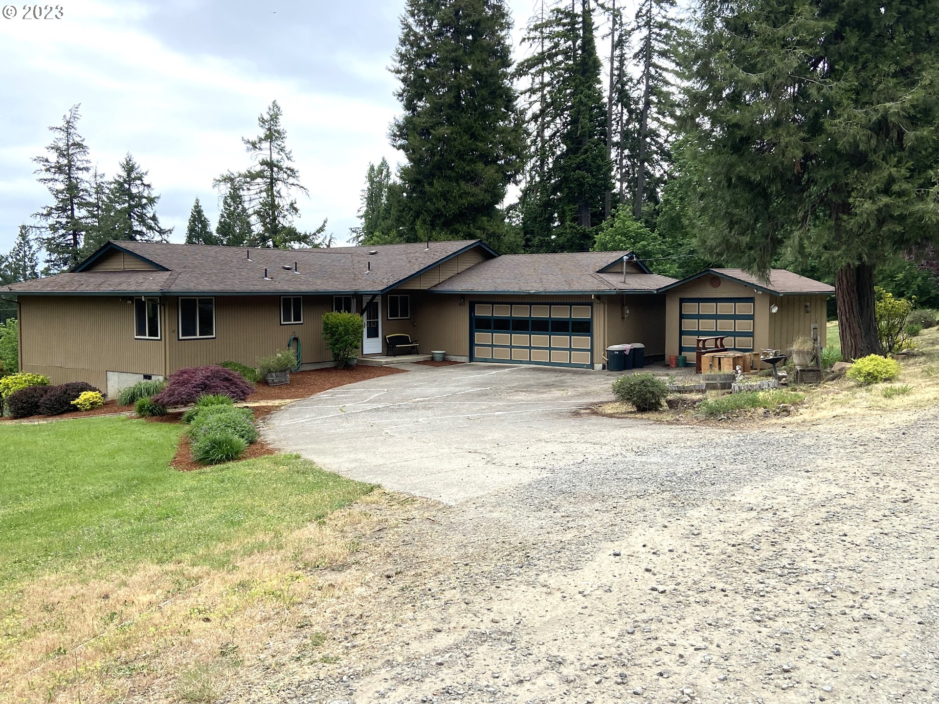7905 South C Street Springfield, OR 97478 - Photo 1 of 28 a backyard of a house with table and chairs