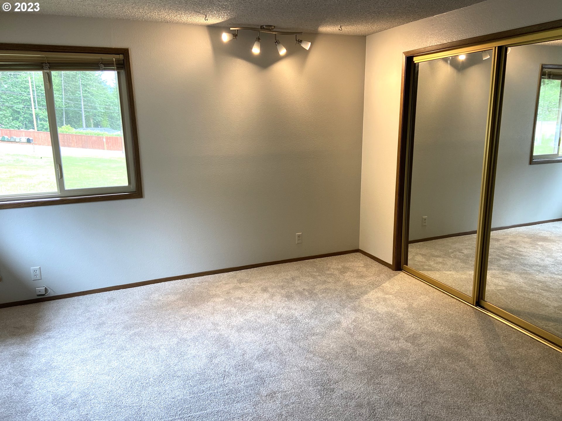 7905 South C Street Springfield, OR 97478 - Photo 14 of 28 a view of an empty room with a window