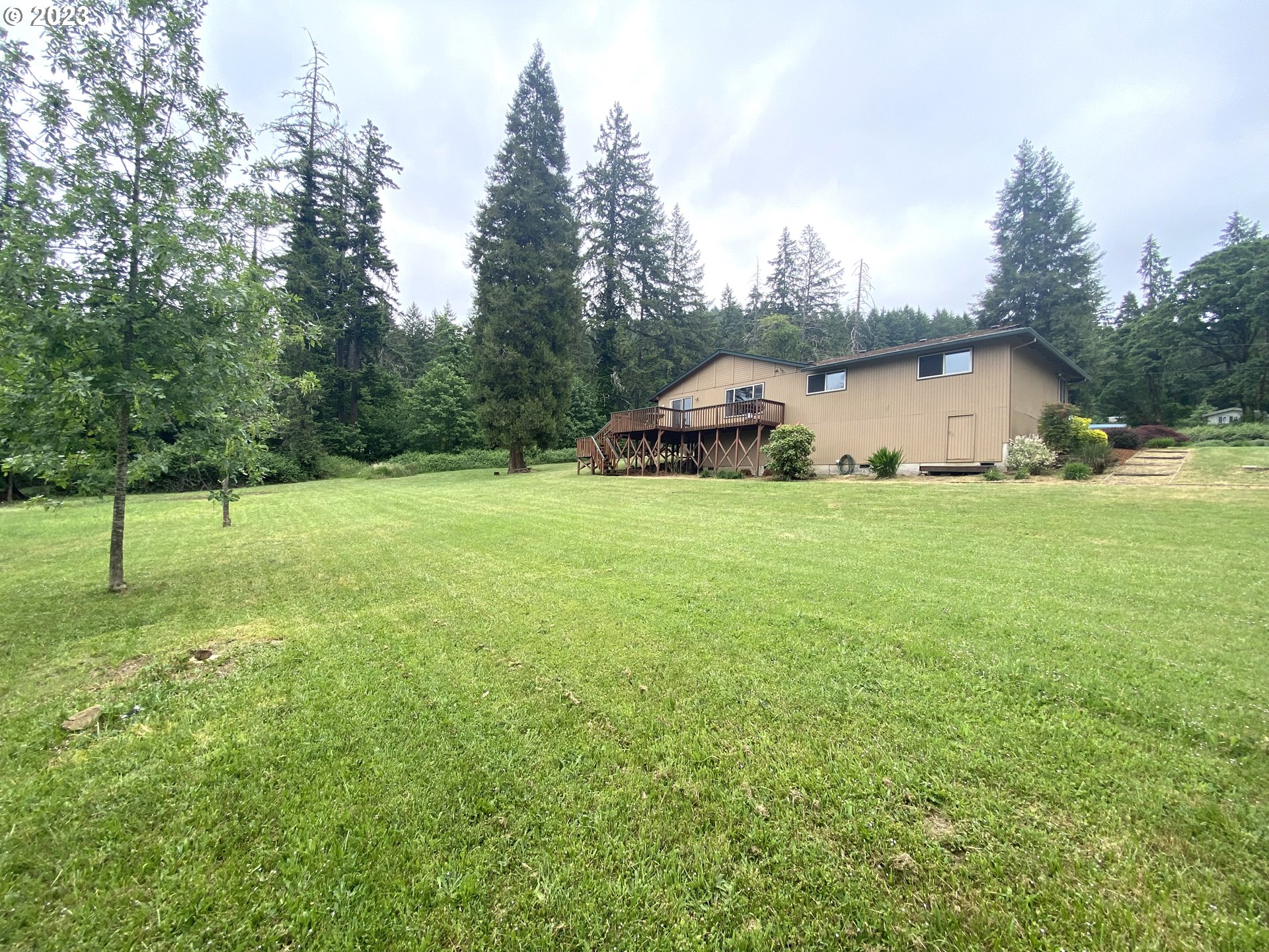 7905 South C Street Springfield, OR 97478 - Photo 19 of 28 a view of a house with a yard and garage