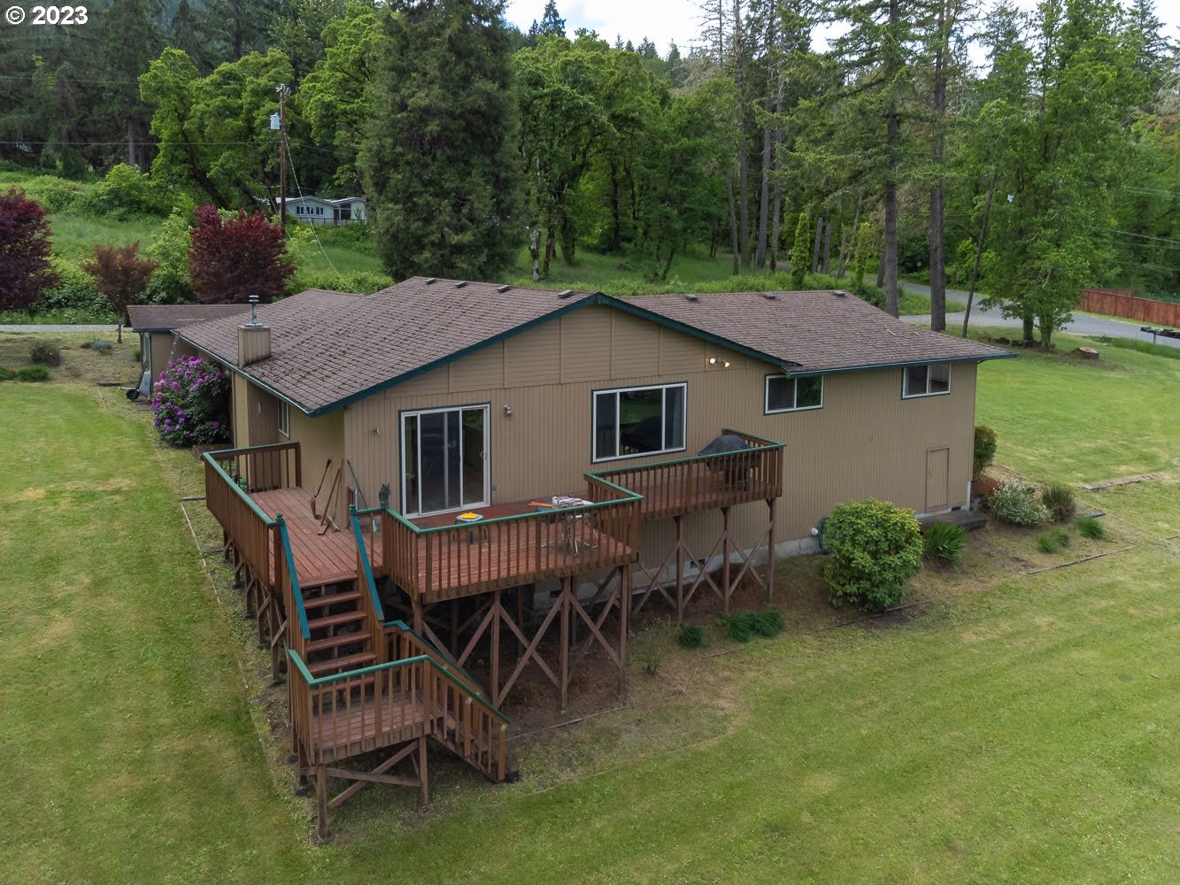 7905 South C Street Springfield, OR 97478 - Photo 20 of 28 a backyard of a house with table and chairs