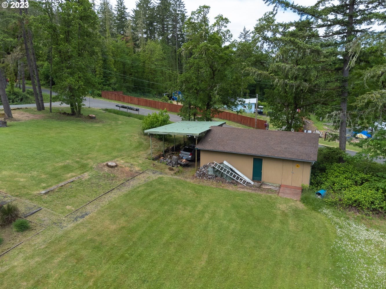 7905 South C Street Springfield, OR 97478 - Photo 23 of 28 a backyard of a house with table and chairs