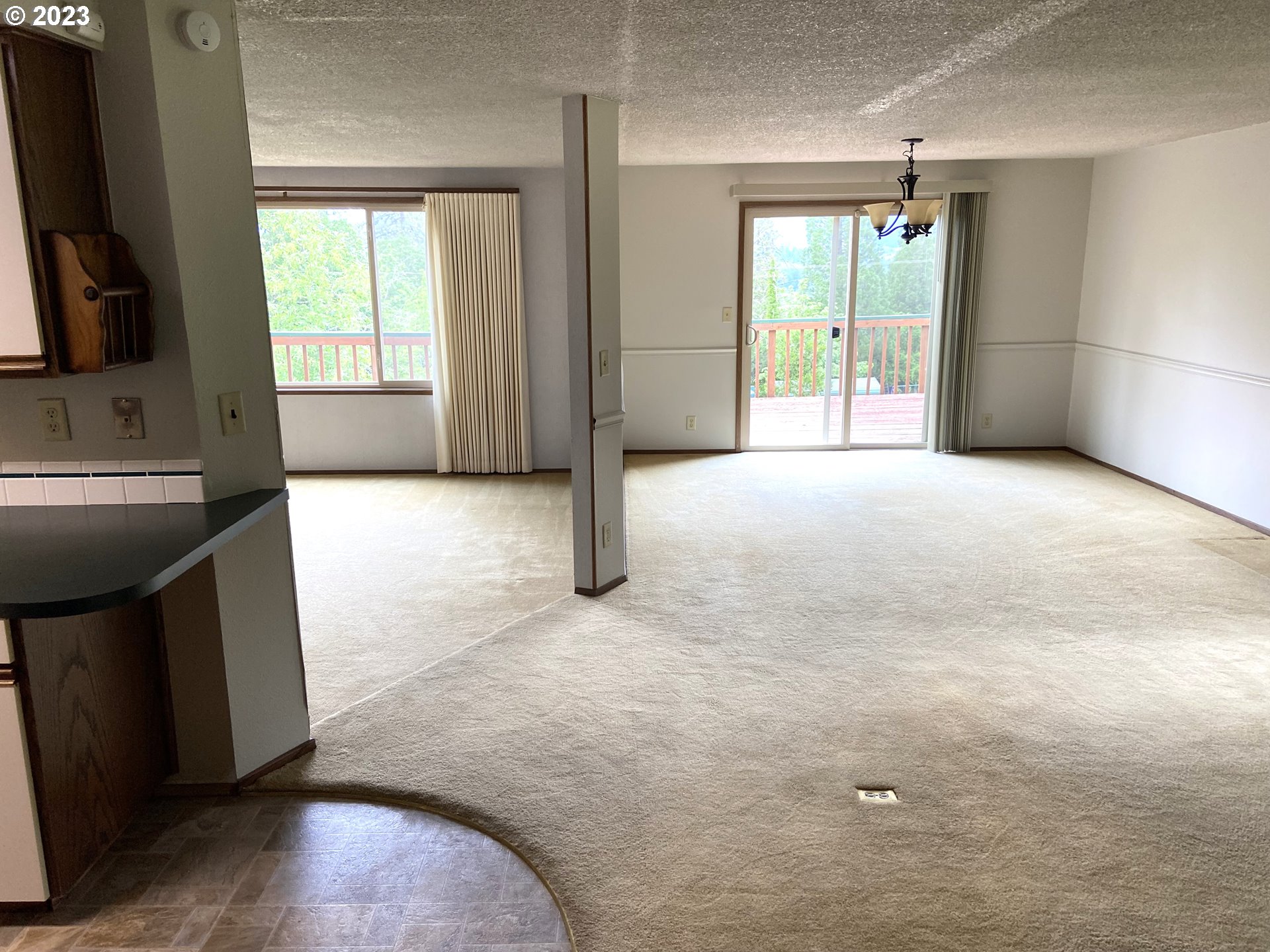 7905 South C Street Springfield, OR 97478 - Photo 5 of 28 a view of an empty room with a fireplace and a window