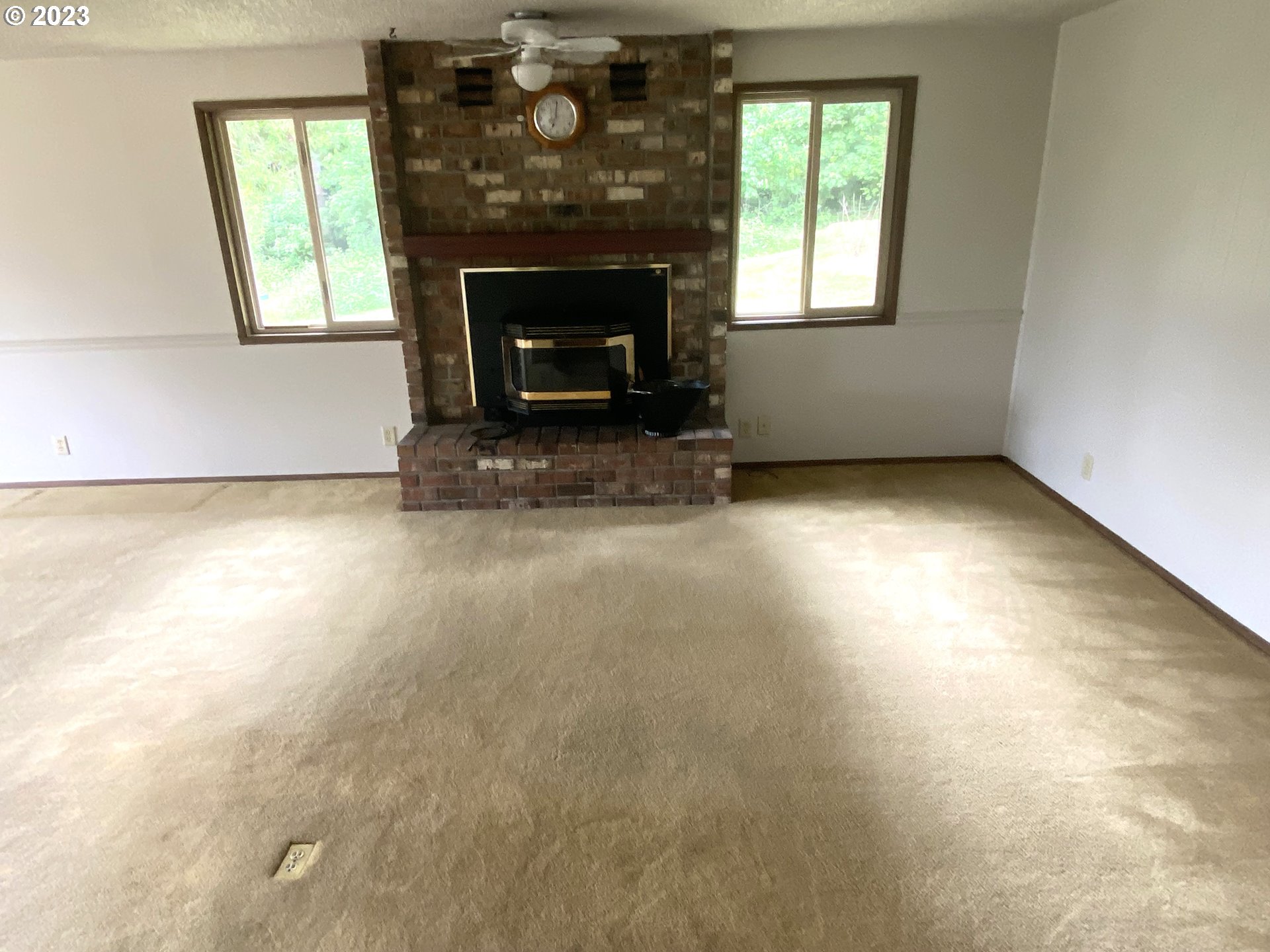 7905 South C Street Springfield, OR 97478 - Photo 7 of 28 an empty room with windows and fireplace