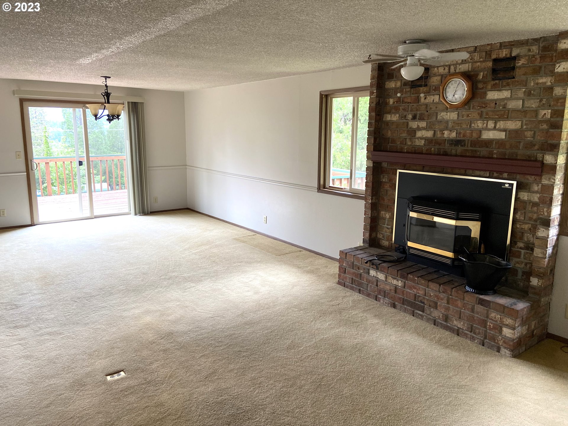 7905 South C Street Springfield, OR 97478 - Photo 8 of 28 a view of empty room with fireplace and window